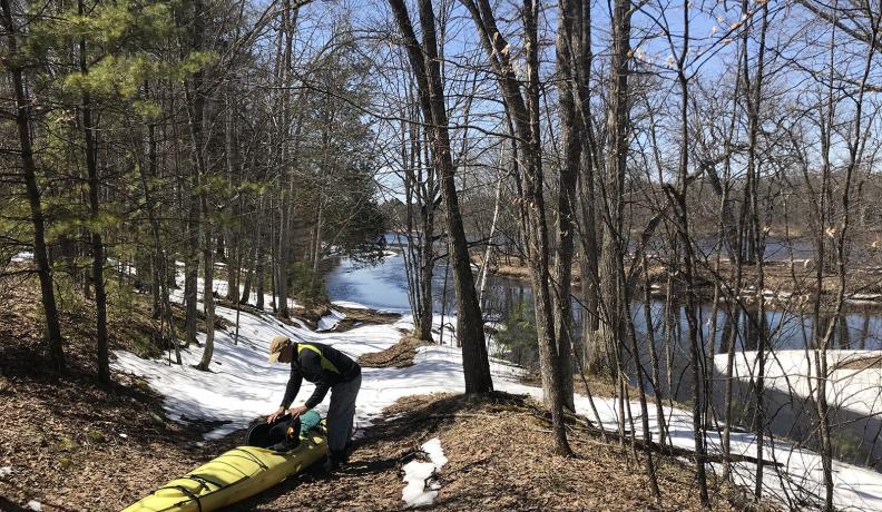 man pulls kayak out of Menominee offshoot